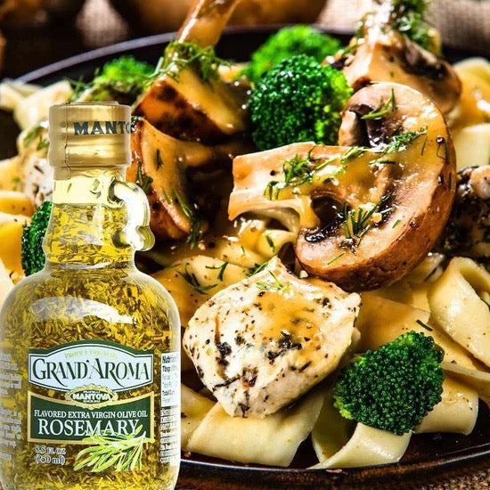 Pasta dish with chicken, mushrooms, and broccoli on a plate with a bottle of Grand'Aroma Rosemary olive oil.
