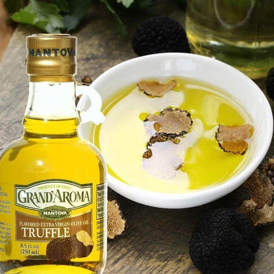 Bottle of Grand'Aroma Truffle olive oil with a bowl of truffle-infused oil on a wooden surface.