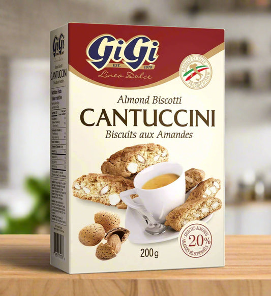 Box of GiGi Cantuccini almond biscotti with a cup of coffee on a white background