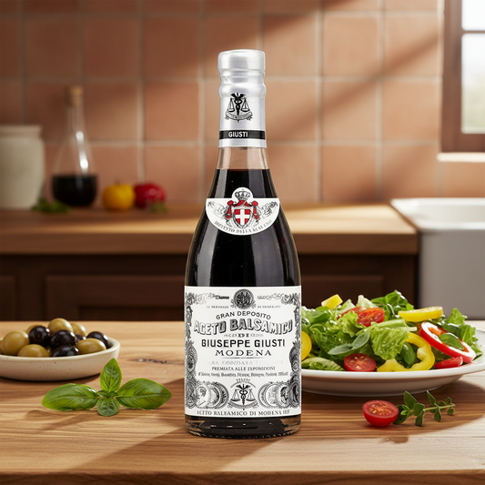 Bottle of Giuseppe Giusti Modena on a wooden surface with a neutral background